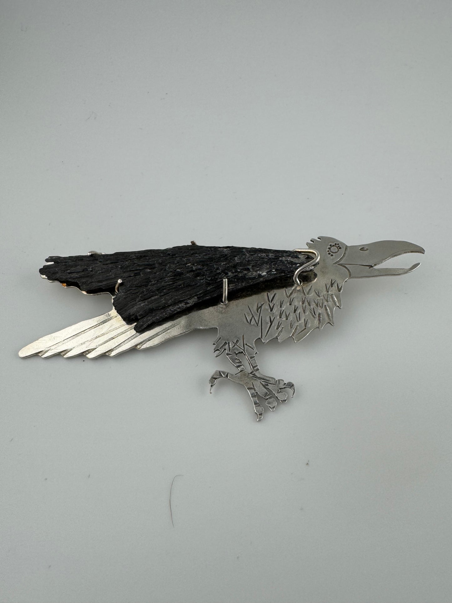 Raven with kyanite stone wing