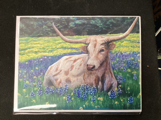Juego de cartas de cuernos largos de Texas en un campo de lupinos azules
